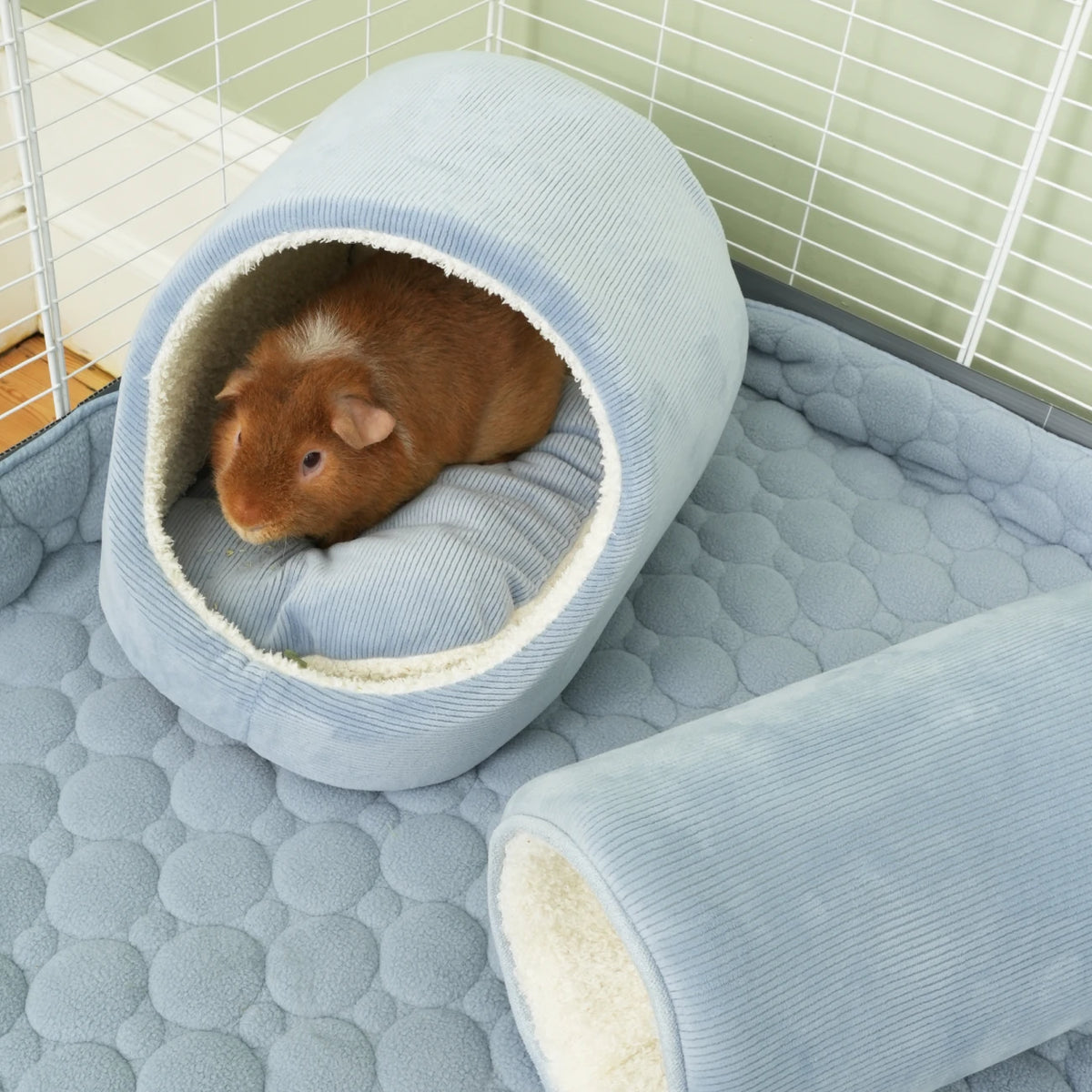 The Cloud™ Fleece Liner in Dusky Blue, in a guinea pig habitat